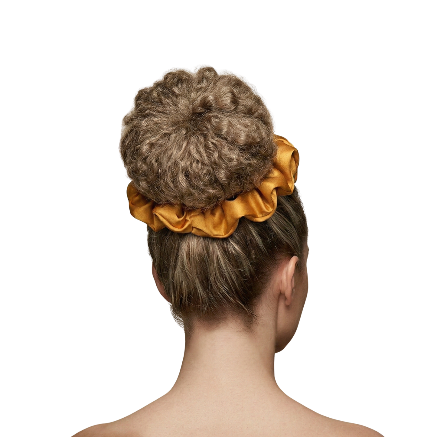 Woman with a bun holding a yellow scrunchie on a white background