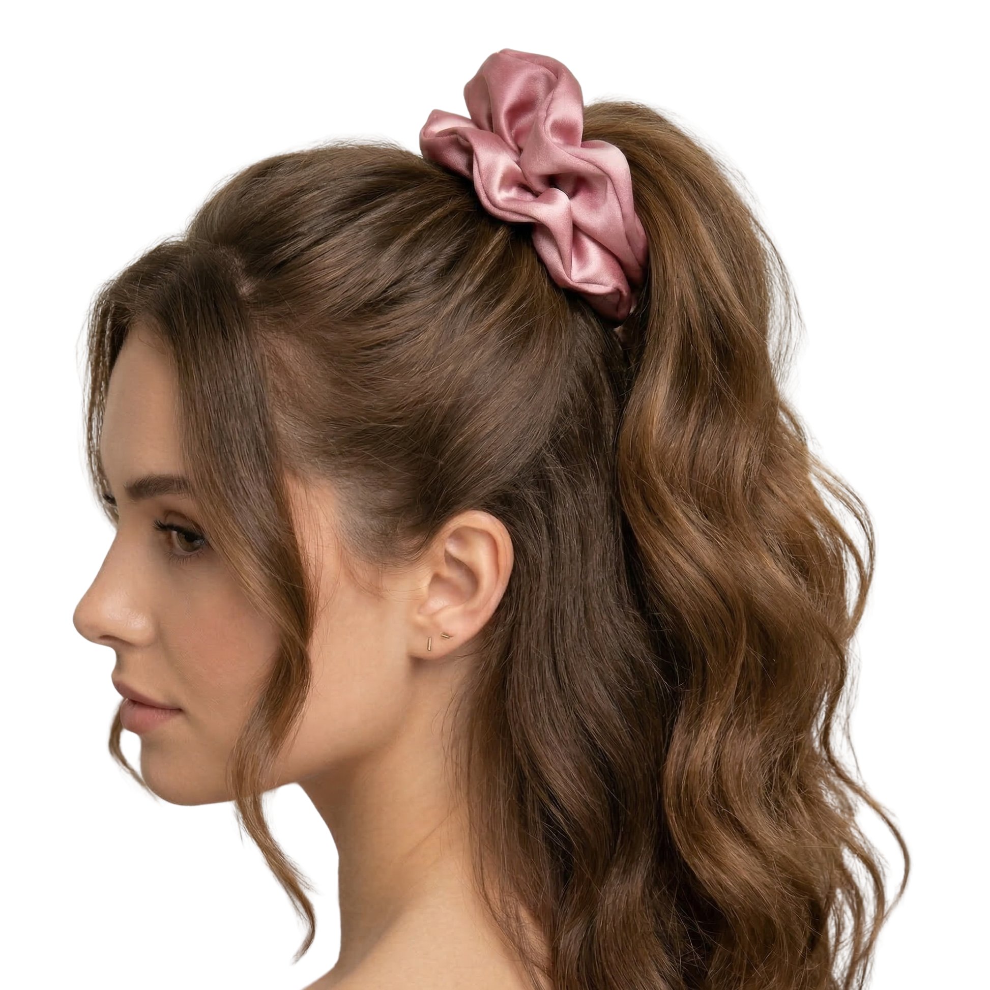 Woman with wavy hair tied in a ponytail with a pink scrunchie on a white background