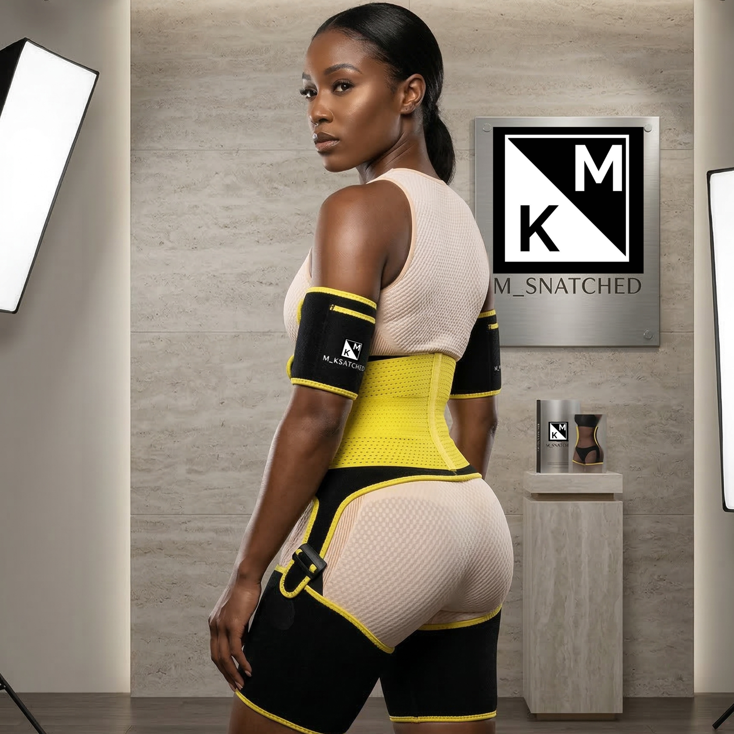 Woman wearing a yellow and black waist trainer in a bathroom setting with MK Snatched branding.