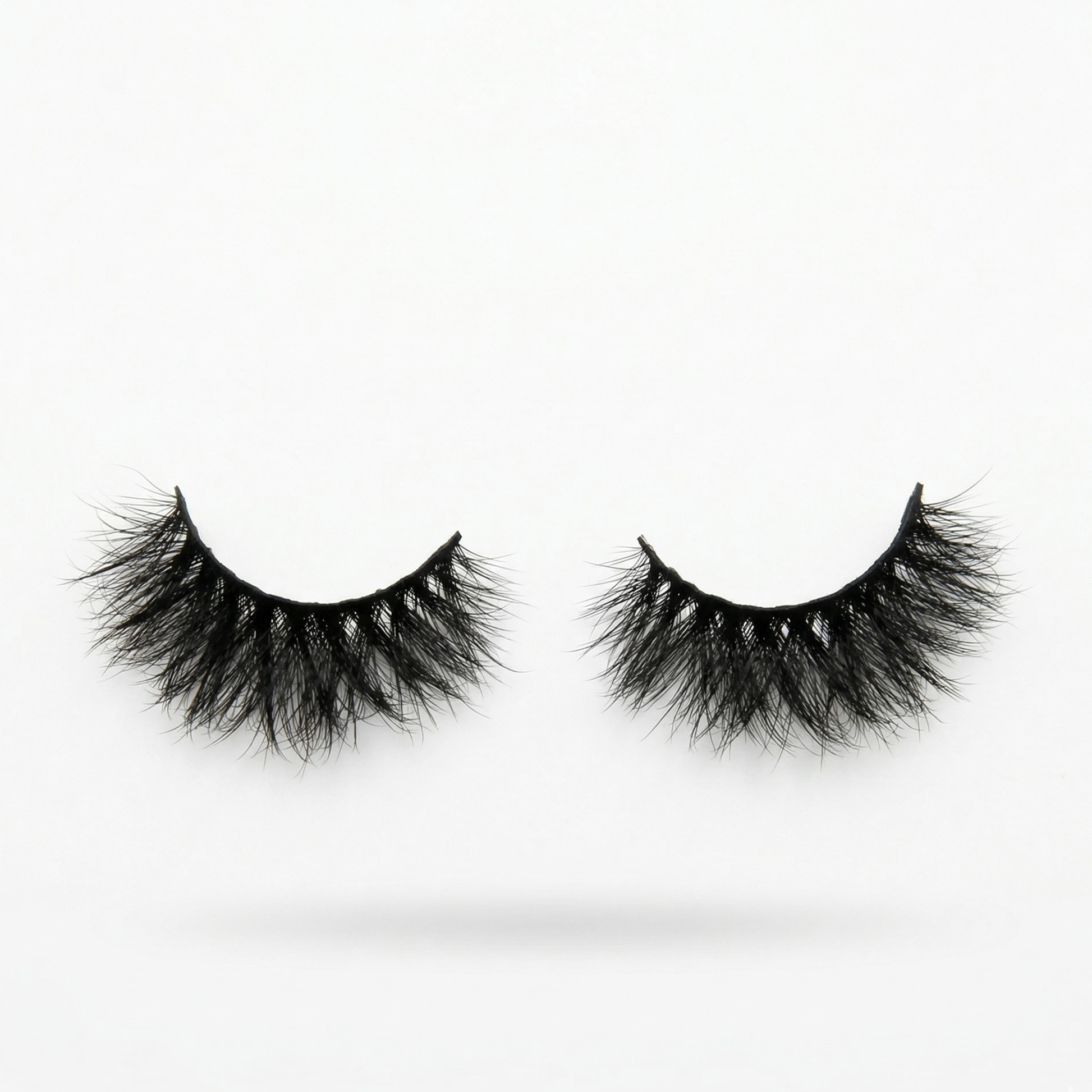Pair of black false eyelashes on a white background