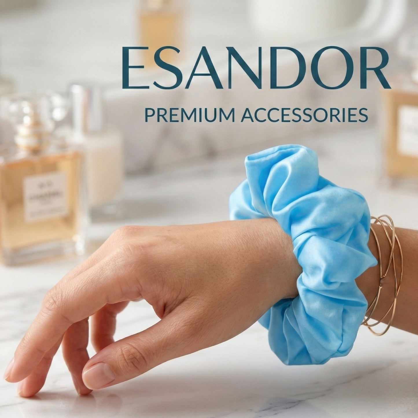 Hand wearing a blue scrunchie with 'ESANDOR' branding in the background.