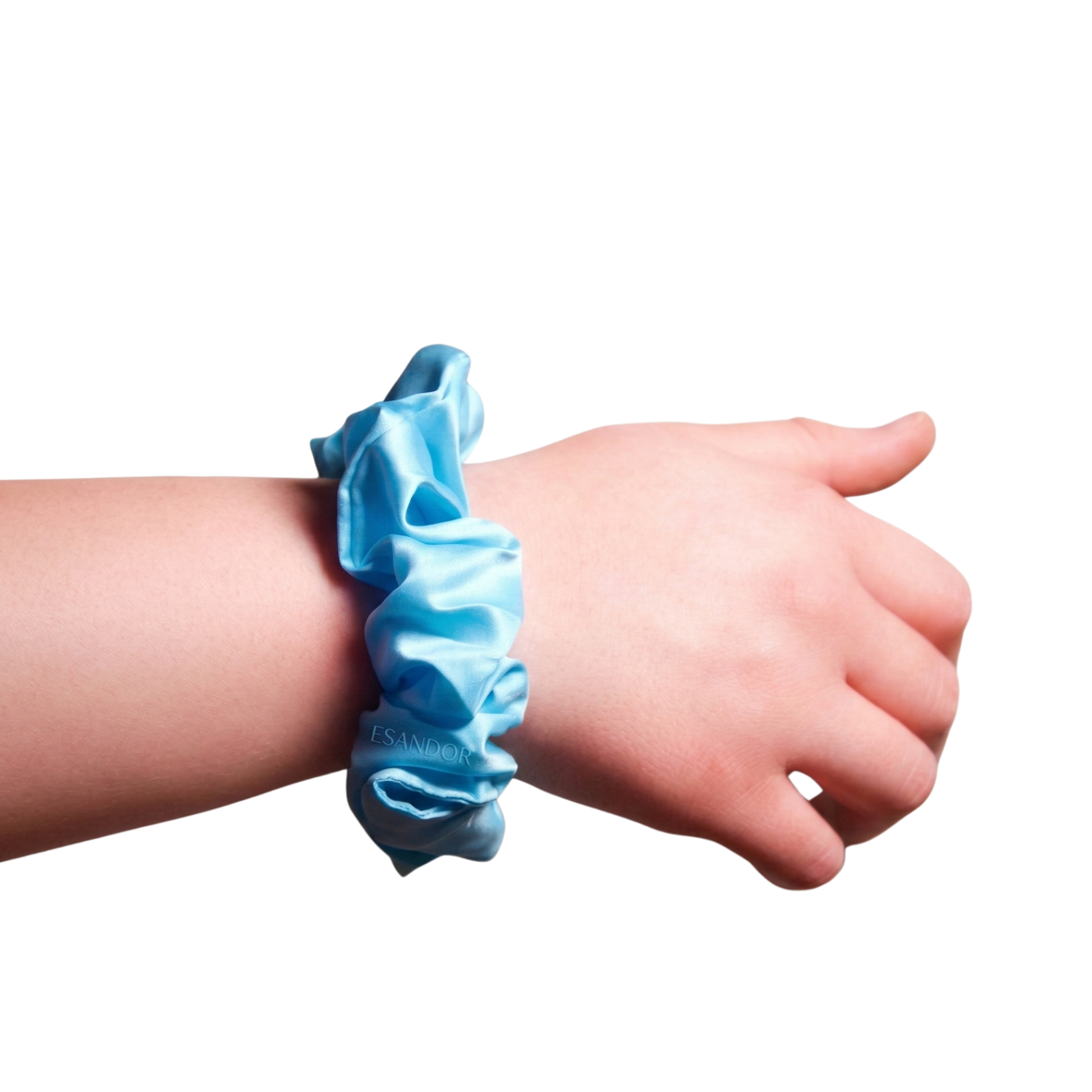 Light blue scrunchie on a wrist against a white background