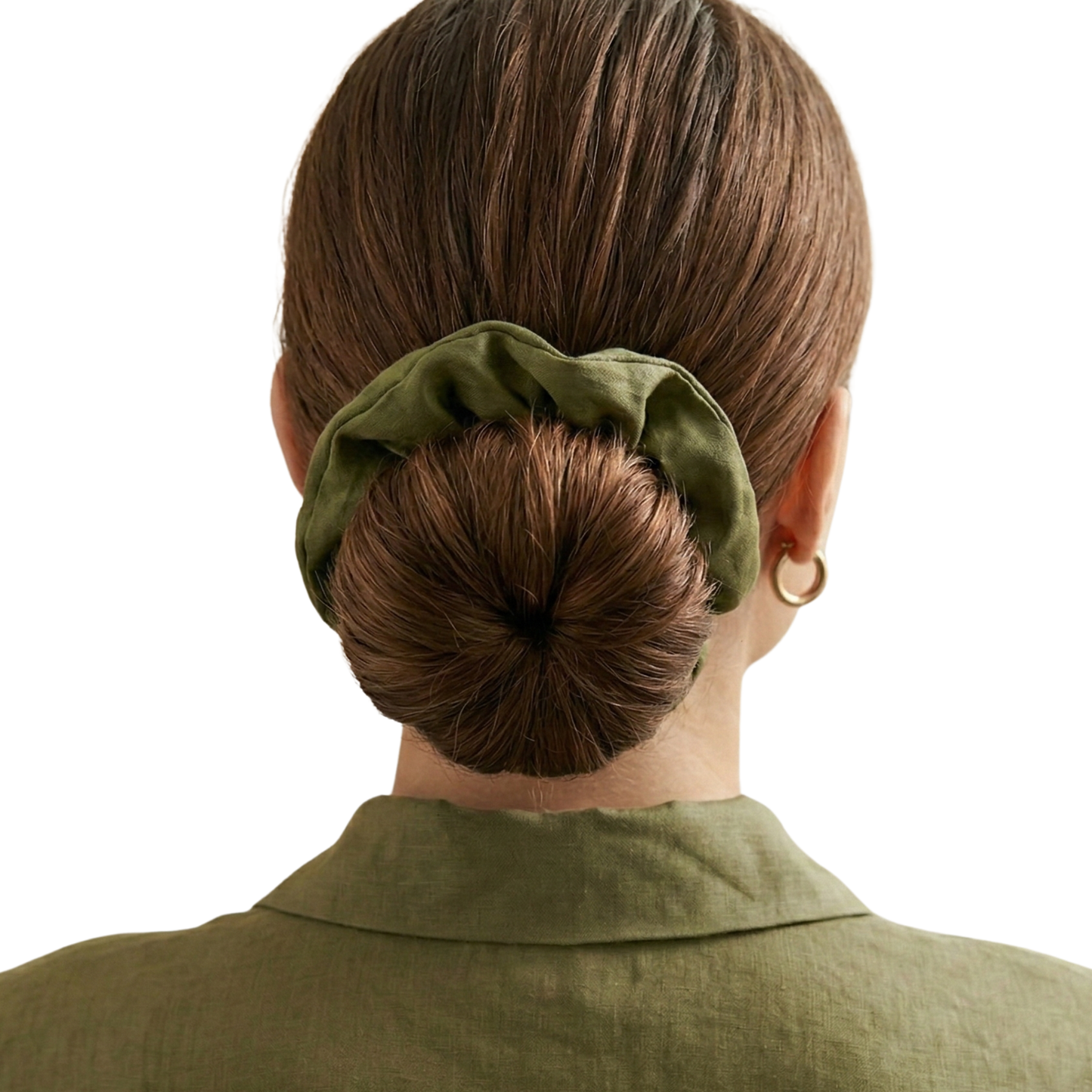 Person with a bun held by a green scrunchie on a white background