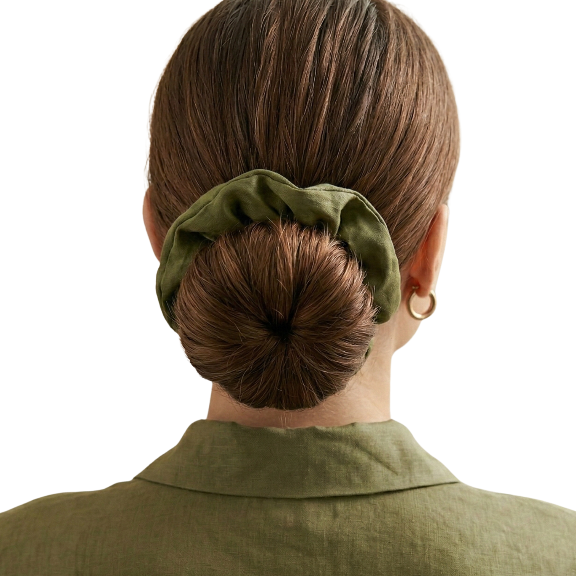 Person with a bun held by a green scrunchie on a white background