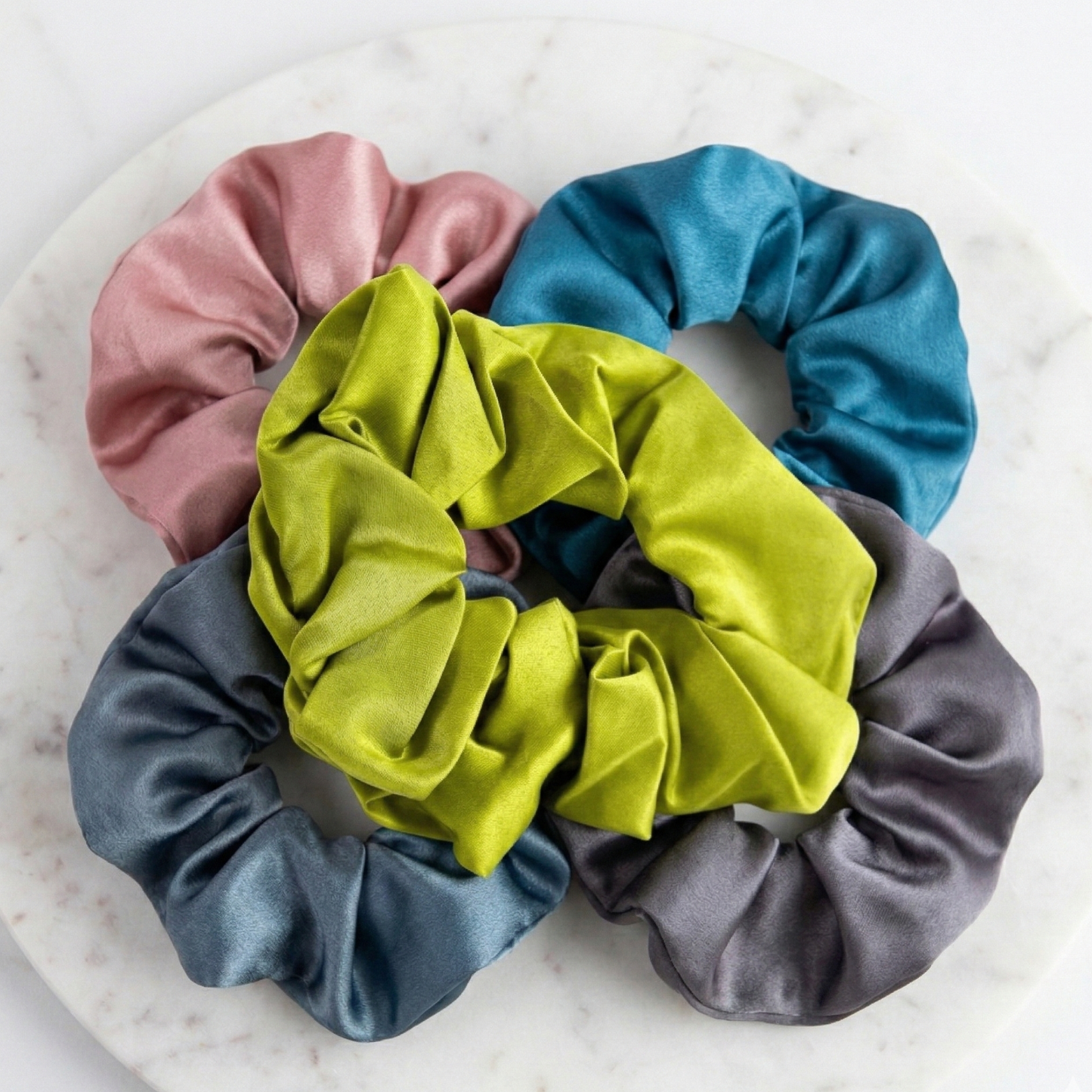 Set of colorful scrunchies on a marble surface